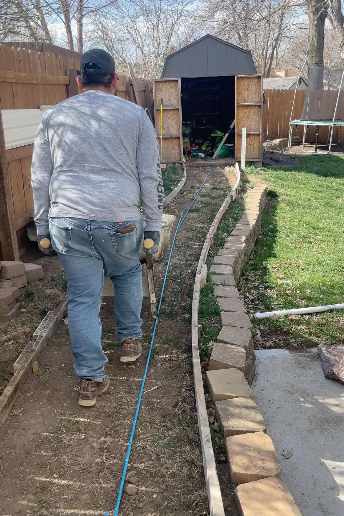 Moving concrete with a wheel barrow. 